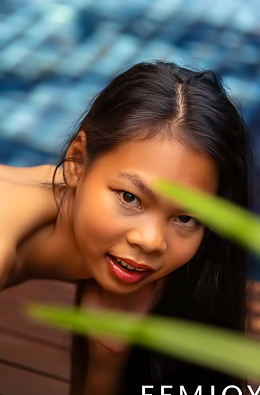 Sultry Por commands from wooden deck in yellow bikini at tropical pool